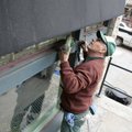  Chuck Decker washes the windows of Bath Junkie on Spring Street in Eureka Springs Monday morning. D...