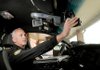 STAFF PHOTO DAVID FRANK DEMPSEY 
Bentonville police officer Guary Morgan demonstrates the use of the car camera and its monitor at the police station on Monday. The police department is in the final year of a six-year project to install cameras in all patrol vehicles.