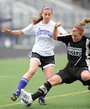 STAFF PHOTO ANDY SHUPE 
Fayetteville sophomore Melanie Lee, left, and Bentonville senior Rylea Wallace vie for the ball during the first half of play Monday at Harmon Field in Fayetteville.