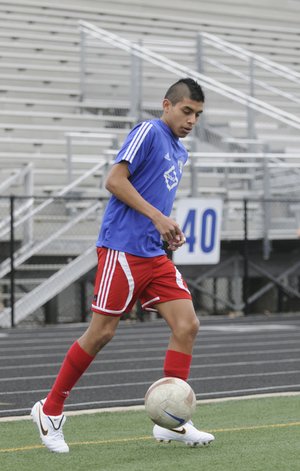 STAFF PHOTO SARAH BENTHAM 
Rogers Heritage’s Phillip Amaya dribbles the ball during practice Monday in Rogers.