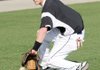 Bentonville shortstop Logan Pearson fields a ground ball during Tuesday’s practice near the Tiger Athletic Complex in Bentonville. Wet field conditions caused the team to move practice to a new location.