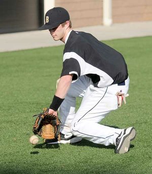 Bentonville shortstop Logan Pearson fields a ground ball during Tuesday’s practice near the Tiger Athletic Complex in Bentonville. Wet field conditions caused the team to move practice to a new location.