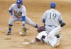 University of Arkansas base runner Collin Kuhn beats the throw to second base as South Dakota State second baseman Scott Hood and shortstop Eric Cain tries to put on the tag in the 8th inning of Tuesday afternoon’s game at Baum Stadium in Fayetteville.