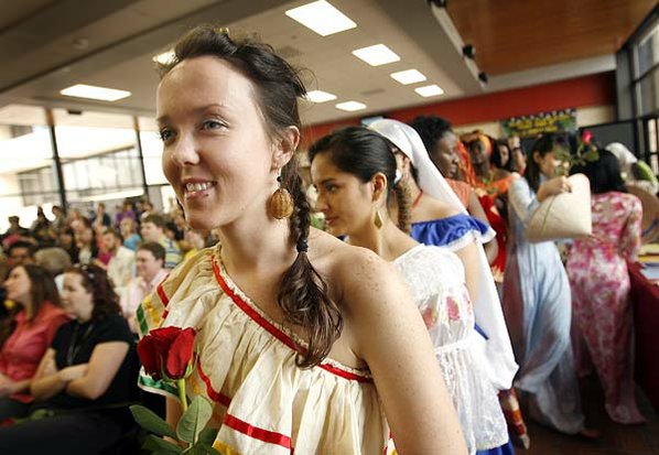 Wearing a traditional Bolivian dress, ...