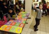 Luz Martinez, 10, tries to lure buyers to her Fast Frames table Wednesday in the student union at NorthWest Arkansas Community College in Bentonville. Martinez joined with other Springdale school district students in learning about free enterprise by developing a business and selling their merchandise at the college.