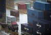  A truck carrying a container runs Yangshan deep-water port Friday, March 5, 2010 in Shanghai, China. China's Premier Wen Jiabao promised strong growth this year and said the government will combat inflation and risks to banks to keep the rebound in the world's third-largest economy on track. 