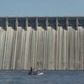 Anglers fish for trout in front of Bull Shoals Dam.