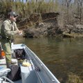 Sandy Kapka, left, works flies while guide Paul Bobby fishes jigs in an eddy off the main flow of th...