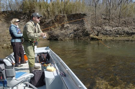 
                               
                                  Photo by Flip Putthoff&mdash;
                               
                           
                           Sandy Kapka, left, works flies while guide Paul Bobby fishes jigs in an eddy off the main flow of the White River.
