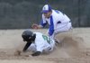Rogers High’s Alex Flowers tries to tag out Van Buren’s Alex Dumas during a game Wednesday at Veterans Park in Rogers.