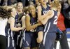 Conway Christian's Kelly Hays (facing) jumps in the arms of her teammate Mallory Clutts (20) and celebrates their victory over St. Joseph in the class 2A girls state championship held Thursday at the Summit Arena in Hot Springs.  