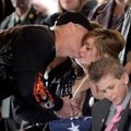 Ron Bender, a Patriot Guard Rider from Broken Arrow, Okla., comforts Sgt. Vincent Owens’ widow, Kait...