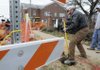  Joe Beckford, right, and Paul Minnitti, both with Electrical Resources of Centerton, prepare to move electrical lines Thursday in downtown Bentonville. Weather delays have pushed back work on the downtown enhancement project but officials believe it will be completed in June.
