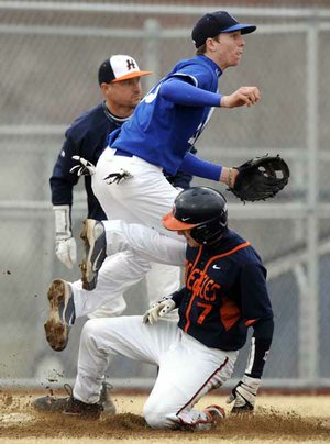  Rogers Heritage’s Grant Driver slides under Conway’s Tyler Langley after beating the throw to third base for a triple Thursday during the third inning of a 1-0 win over the Wampus Cats in the Best Sports Classic at Veterans Park in Rogers. Driver’s triple set up the only score of the game.
