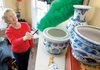 Willette Lollar uses a feather duster to keep the dust off the items in her home.