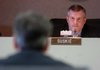 Paul Suskie, chairman of the Public Service Commission, listen as Hugh McDonald, CEO of Entergy Arkansas, testifies Thursday before the commission.