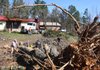 Friends and relative uses chainsaws to remove fallen trees from a home along Hwy. 5  west of Benton in Saline County Thursday morning