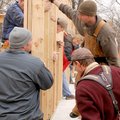 Volunteers raise the east wall of a Habitat for Humanity house Friday at 402 S.W. “B” St. in Bentonv...