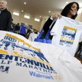 Anna Moses checks the fit on her complimentary T-shirt after checking in for the Bentonville Half Ma...