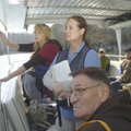 Dixie Ambroes, left, points out geological features on the Beaver Lake shoreline during a training c...