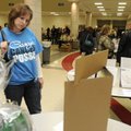 Angie Knox, Casey Wolfe’s cousin from Harrisonville, Mo., looks over silent auction items Friday dur...