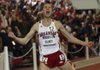 Arkansas’ Dorian Ulrey yells after winning the 3,000 meters at the NCAA Indoor Championships on Saturday in Fayetteville.