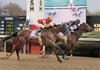 Lookin At Lucky (2) made a late surge to overtake Noble’s Promise (inside) and win the $300,000 Rebel Stakes in front of a season-high crowd of 36,298 at Oaklawn Park in Hot Springs. 