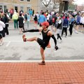 Geoff Rahmer of Bentonville stretches and warms up Saturday before the start of the Bentonville Half...