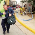 CHEMICAL SPILL - Fayetteville firefighter Larry Balding pulls firehose Saturday as a precaution as o...