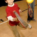 HEALTHY HIT - Aaron Logan smacks a tennis ball Saturday at the Yvonne Richardson Center during a com...