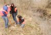Volunteers Tess Spencer 11, from left, Katie Barger, 12, and Alexandra Lopez, 11, plant a green ash seedling Saturday along the banks of Clabber Creek in Fayetteville. Volunteers were at six locations in Northwest Arkansas and Oklahoma planting trees and cleaning streams as part of the Illinois River Watershed Partnership 2010 Riparian Project.