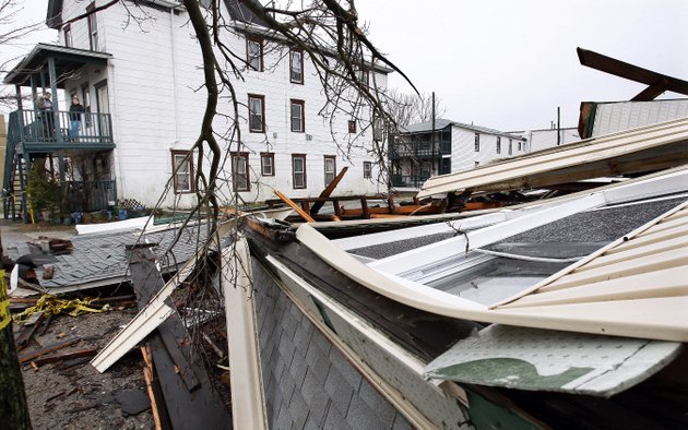 people-left-back-stand-on-the-porch-of-a-home-sunday-in-atlantic-city-nj-overlooking-the-debris-of-a-neighbors-house-that-collapsed-in-the-storm-that-pounded-the-region-saturday