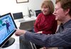 Dana Moore and his wife, Jane, look at avatars on the Second Life Web portal, where he’s an entrepreneur.