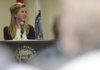 Caroline Kelley with the Rogers High School Business Academy speaks Friday at City Hall to area officials about a plan to revitalize the downtown area. Students from the academy were given the problem of bringing more young people to the downtown area.