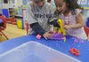 Eric Sifuentes, left, and Emely Martinez enjoy some free time Thursday at the Early Childhood Center in Springdale.