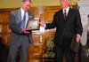 Gov. Mike Beebe presents a plaque to a representative from Conway High School, one of eight schools selected to take part in the Arkansas Advanced Initiative for Math and Sciences program.