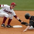 University of Arkansas short stop Tim Carver tags out Wisconsin-Milwaukee Shaun Wegner out at second...
