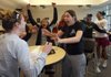 UALR Lady Trojans players Kim Sitzmann, left, Britteni Williams, Channon Haywood, Whitney Burgess react seconds after learning that they earned a bid to the NCAA tournament Monday afternoon on campus.  At right are Kim Davis, director of operations, left, and Jocelyn Love, assistant coach.