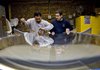  Eugenio Alicea, left, prepares two pieces of glass for lamination with his brother Ezequiel at Flickinger Glassworks in the Brooklyn borough of New York, U.S., on Tuesday, March 2, 2010. Manufacturers increased production and employment in February, signaling factories are leading the nation out of recession as the new year begins. 