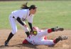 Bentonville second baseman Meg McGuirt, left, applies the late tag as Farmington’s Teighlor Williams steals second base during the first inning of the Lady Cardinals’ 6-5 win in the first game of Monday’s doubleheader in Farmington.