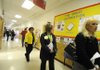 Area educators view a U.S. history timeline on display in the Leverett Elementary School hallways during the National School Boards Association technology visit Monday. The timeline was a computer-based project with assistance from University of Arkansas senior childhood education students.