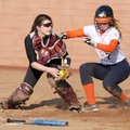 Rogers Heritage’s Lauren Bundy, right, scores before being tagged by Siloam Springs catcher Ashley L...