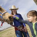 Mary Claire Gill, 6, a first-grader at Bernice Young Elementary School in Springdale, pets a horse h...