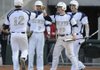Shiloh Christian’s David Petrino, right, meets Josh Salsbury at home plate after Salsbury scored against Van Buren during Monday’s game in Springdale.