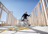 Construction workers frame a house in Mesa, Ariz., in February. The Commerce Department said Tuesday that housing starts fell in February.