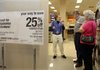 Sears appliance salesman Blane Moore (L) talks with Don and Emma Farris of Hampton about the energy star rebate program being offered for the purchase of certain home appliances.