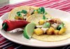 Pork Loin in Chile Adobo With Grilled Pineapple Tacos topped with cilantro and Green Salsa combine spicy chile peppers with soothing pineapple.