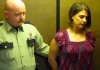 An officer escorts Amber Turley into an elevator at the Conway County Courthouse after she was sentenced to two years in prison as part of a plea deal in the deaths of her three sons.