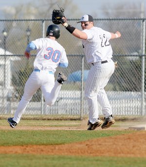 After tagging a Fort Smith Southside runner out, Bentonville first baseman Arthur Flowers throws to second during Tuesday’s game in Bentonville.