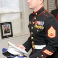 Marine Corps Staff Sgt. John Cheze carries the U.S. flag Tuesday to be presented to the Northwest Ar...
